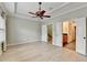 Inviting bedroom features plantation shutters, a ceiling fan, and a tray ceiling at 1668 Sabastian Ne Pt, Atlanta, GA 30329