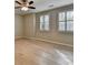 Bright bedroom featuring neutral paint, modern ceiling fan, wood floors, and shuttered windows with natural light at 1668 Sabastian Ne Pt, Atlanta, GA 30329