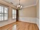 Dining room featuring hardwood floors, two windows, and elegant chandelier at 1668 Sabastian Ne Pt, Atlanta, GA 30329