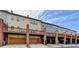 Exterior view of townhome units with car garages, and a brown deck at 1668 Sabastian Ne Pt, Atlanta, GA 30329