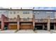 Exterior view of townhome units with car garages, and a brown deck at 1668 Sabastian Ne Pt, Atlanta, GA 30329