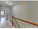 Bright hallway with wood floors, a staircase with wood railing, and natural light at 1668 Sabastian Ne Pt, Atlanta, GA 30329