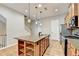Kitchen featuring a granite island, modern lighting, and open layout at 1668 Sabastian Ne Pt, Atlanta, GA 30329
