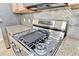 Stainless steel gas range with granite backsplash and countertops at 1668 Sabastian Ne Pt, Atlanta, GA 30329
