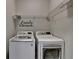 The laundry room features washer and dryer with wire rack for storage at 1668 Sabastian Ne Pt, Atlanta, GA 30329