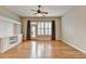 Bright living room featuring hardwood floors, built-in shelving, and a ceiling fan at 1668 Sabastian Ne Pt, Atlanta, GA 30329