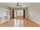 Bright living room featuring hardwood floors, built-in shelving, and a ceiling fan at 1668 Sabastian Ne Pt, Atlanta, GA 30329