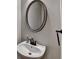 Charming powder room with modern fixtures and a sleek oval mirror at 1668 Sabastian Ne Pt, Atlanta, GA 30329