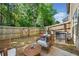 Cozy backyard features patio seating, a wooden fence, and lush greenery for relaxation at 5157 Madeline, Stone Mountain, GA 30083