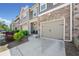 Lovely townhouses exterior with stone detail, driveway, and manicured landscaping at 5157 Madeline, Stone Mountain, GA 30083