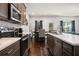 Well-equipped kitchen with stainless appliances, dark cabinets, and a view to the dining area at 5157 Madeline, Stone Mountain, GA 30083