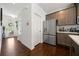 This modern kitchen area features stainless appliances, sleek cabinets, and hardwood floors at 5157 Madeline, Stone Mountain, GA 30083