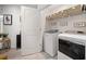 Well-organized laundry room with modern appliances and storage shelving at 5157 Madeline, Stone Mountain, GA 30083