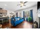 Inviting living room featuring a modern blue sofa, fireplace, hardwood floors, and lots of natural light at 5157 Madeline, Stone Mountain, GA 30083