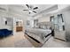 Spacious main bedroom with a large bed, tray ceiling, ensuite bathroom, and carpeted floors at 5157 Madeline, Stone Mountain, GA 30083