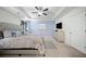 Bright main bedroom showcasing a calming blue accent wall, tray ceilings, and contemporary furnishings at 5157 Madeline, Stone Mountain, GA 30083