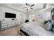 Bright main bedroom showcasing tray ceilings, contemporary furnishings, and an ensuite bathroom at 5157 Madeline, Stone Mountain, GA 30083