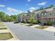 Exterior street view of a row of townhouses with well-manicured lawns at 5157 Madeline, Stone Mountain, GA 30083