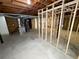 Unfinished basement featuring exposed beams and framed walls, ready for customization at 6092 Leverett Dr, Lithonia, GA 30038