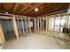 Unfinished basement featuring exposed beams and framed walls, ready for customization at 6092 Leverett Dr, Lithonia, GA 30038
