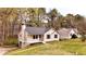 Cozy one-story home featuring a covered porch and a manicured lawn at 6092 Leverett Dr, Lithonia, GA 30038