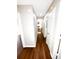 Hallway with hardwood floors and white trim, connecting different parts of the residence at 6092 Leverett Dr, Lithonia, GA 30038