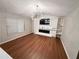 Spacious living room with hardwood floors, modern lighting, and a sleek fireplace at 6092 Leverett Dr, Lithonia, GA 30038