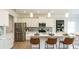 Bright kitchen featuring white cabinets, stainless steel appliances, and a quartz countertop island with seating at 233 Silver Leaf Trce, Douglasville, GA 30134