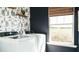 Well-designed laundry room featuring a window and nature-themed wallpaper at 233 Silver Leaf Trce, Douglasville, GA 30134