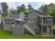 The back exterior features siding, a deck and screened porch in a large grassy backyard at 2015 Brookstone Ct, Lithia Springs, GA 30122