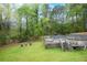 Large backyard with a wooden fence, mature trees, and a tiered deck area at 2015 Brookstone Ct, Lithia Springs, GA 30122