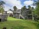 Spacious backyard featuring a deck, lush green grass, and mature trees for outdoor enjoyment at 2015 Brookstone Ct, Lithia Springs, GA 30122