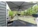 Outdoor deck with white railings, patio furniture, and a large umbrella at 2015 Brookstone Ct, Lithia Springs, GA 30122