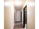 Long hallway with neutral walls and black door trim at 2015 Brookstone Ct, Lithia Springs, GA 30122