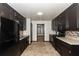 Galley kitchen with dark cabinetry, stainless steel appliances, and tile backsplash at 2015 Brookstone Ct, Lithia Springs, GA 30122
