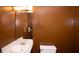 Small powder room featuring a large mirror, modern vanity, and neutral-toned walls at 2015 Brookstone Ct, Lithia Springs, GA 30122