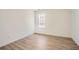 Cozy bedroom featuring wood-look floors and a window providing natural light at 3647 Bancroft Main Nw, Kennesaw, GA 30144