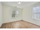 Sunlit bedroom with hardwood floors and large windows offering pleasant outdoor views at 3647 Bancroft Main Nw, Kennesaw, GA 30144