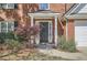 Welcoming front entrance with a black door, white columns, and lush landscaping at 3647 Bancroft Main Nw, Kennesaw, GA 30144