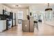 Open concept kitchen with stainless steel appliances and stylish breakfast bar seating at 3647 Bancroft Main Nw, Kennesaw, GA 30144