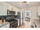 Modern kitchen with granite countertops, stainless steel appliances, and white cabinetry at 3647 Bancroft Main Nw, Kennesaw, GA 30144