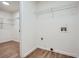 Well-lit laundry room with shelving and washer/dryer hookups, offering convenience and functionality at 3647 Bancroft Main Nw, Kennesaw, GA 30144