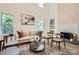 Cozy living room with a fireplace, wood floors, neutral decor, and plenty of natural light at 3647 Bancroft Main Nw, Kennesaw, GA 30144