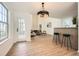 Bright open living room with high ceilings that flows into the kitchen. Features wood floors and neutral decor at 3647 Bancroft Main Nw, Kennesaw, GA 30144
