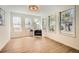 Sunroom/sitting room with wood floors and natural light from windows. A single chair gives the room a clean aesthetic at 3647 Bancroft Main Nw, Kennesaw, GA 30144
