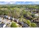 A residential neighborhood aerial showcasing the community nestled in a forest and around a pond at 3950 Almandine Way, Cumming, GA 30040