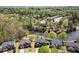 An aerial view of a suburban neighborhood featuring houses surrounding a pond and lush trees at 3950 Almandine Way, Cumming, GA 30040