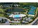 Aerial view of a community center featuring a pool, tennis courts, and a picturesque pond at 3950 Almandine Way, Cumming, GA 30040