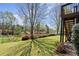 Lush backyard leading to a tranquil pond, with a wood deck and stairs visible at 3950 Almandine Way, Cumming, GA 30040