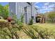 View of the manicured backyard of a two-story home with a wood deck and stairs at 3950 Almandine Way, Cumming, GA 30040